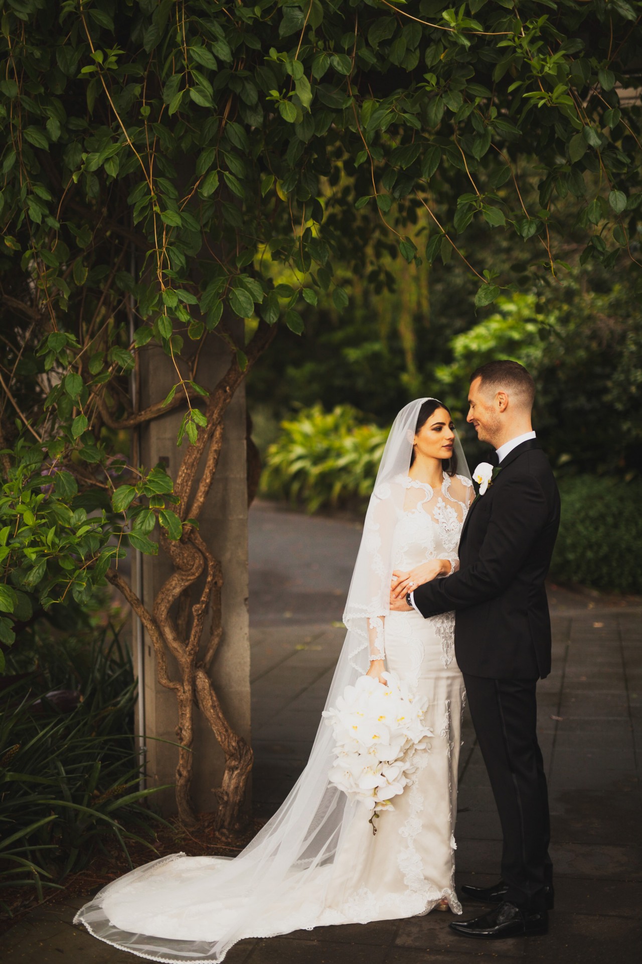 Tori and Tom incorporated their Buddhist beliefs into their white garden wedding. Image: 