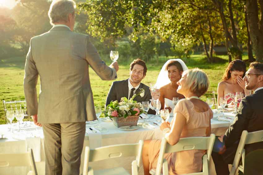 The father-of-the-bride toasting the happy couple.