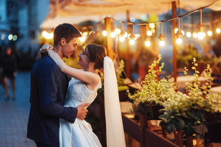 wedding couple at night lighting. Cafe along with decoration lig