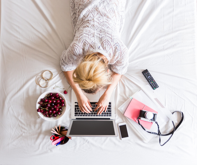 Woman using a laptop in the bed