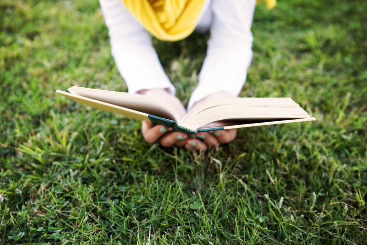 Person is Reading a Book in Nature